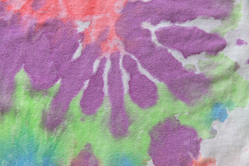 Pastel tie dye, a handmade pattern on a cotton t-shirt. Close-up, top view. DIY concept,...