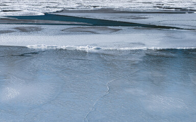 Beautiful abstract ice patterns in frozen stream
