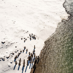 The importance of pier support;  a rotting pier in a winter landscape