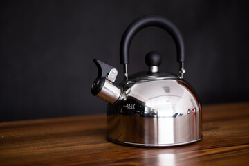 silver kettle on wooden background