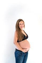 Portrait of pretty pregnant blonde woman smiling happy touching belly