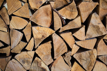 Stacked firewood close-up. Firewood storage close up. Stocks of wooden logs close-up. Chopping wood. Logging in the village.