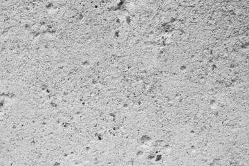 Texture of gray concrete with recesses of different sizes