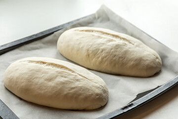 Yeast buns on a baking sheet