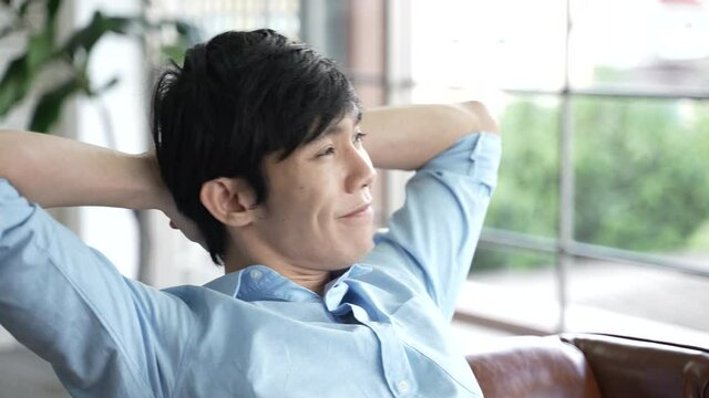 young man person relaxing after work, office business worker lifestyle, sleepy and relieve stress when successful of business work, slow motion shot, working job from home on online cyberspace