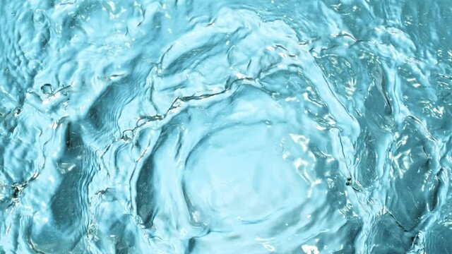 Super Slow Motion Shot of Water Splash at 1000fps on Blue Gradient Background.