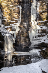 Lake Falls waterfall frozen on a cold winter day.  Matthiessen state park, Illinois, USA.