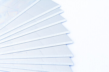 Blades for stationery knives, close-up. Segmented knife blades on a white background. Stationery.