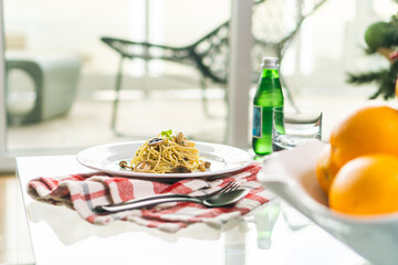 served pasta dinner table with drink