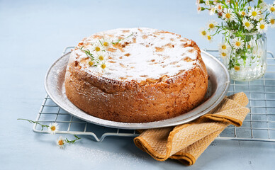 Homemade apple cake for Mother's Day, on light blue background with copy space. Healthy Easy bakery concept. Summer, Spring time recipe step by step. Birthday Cake card Background.
