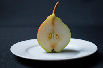 half of sweet pear on white plate