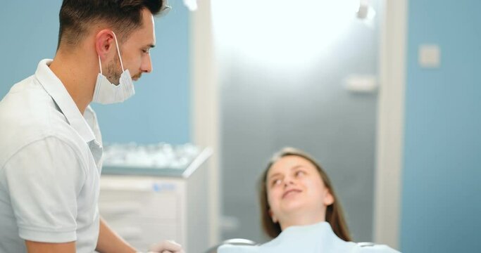 Small talk between patient and dentist, preparing for the dental check up at the dental office. Regular visit to the orthodontist