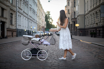 Fototapeta na wymiar Woman walking with beautiful stroller