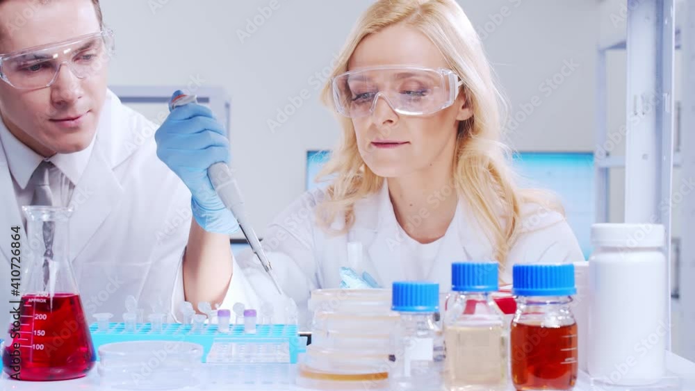 Poster Professional team of scientists is working on a vaccine in a modern scientific research laboratory. Genetic engineer workplace. Futuristic technology and science concept.