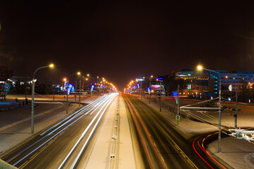 Fototapeta na wymiar Road in the winter night, city, cars, lights, speed.