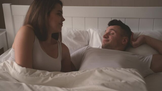 The young couple awakening in the bed