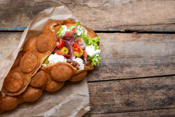 Top view of waffle stuffed with meat and olives