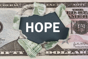 The dollar is torn in the center. In the center it is written - HOPE