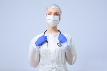 Portrait of a female doctor or nurse wearing medical cap and face mask
