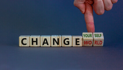 Change world or yourself symbol. Businessman turns wooden cubes and changes words 'change world' to 'change yourself'. Beautiful grey background, copy space. Business and change yourself concept.
