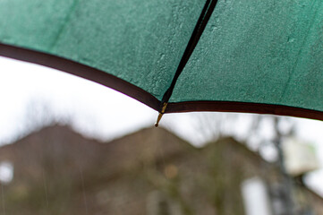 Dark green umbrella in rainy day