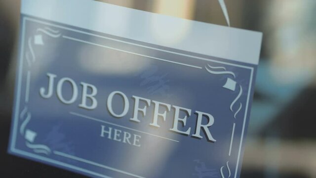 Plate with the inscription JOB OFFER on the entrance glass door in 4k Slow motion 60fps