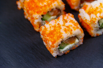 Sushi rolls Philadelphia on a black slate