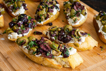 Herbed Olive Tapenade With Goat Cheese Bruschetta: Appetizer made of olive tapenade and goat cheese spread on toasted ciabatta bread