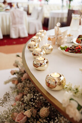 wedding table decorated with beautiful candles and different colors. festive food on the table. wedding banquet.