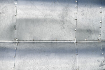 Sheet metal riveted, waved, weathered surface background image.