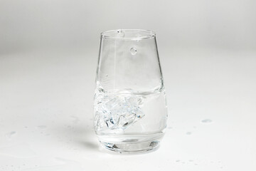 clean water is poured into a glass cup. ice in a glass.