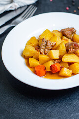 stewed potatoes and meat roast vegetables goulash portion on the table for healthy meal snack...