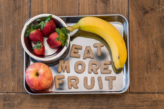 Fruit Snack Tray with Strawberries, Apples, Bananas with Cookies spelling "Eat More Fruit"