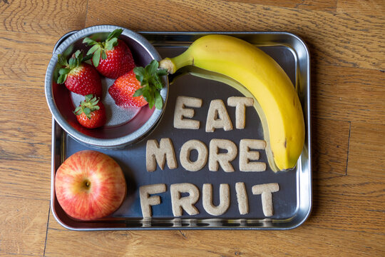 Fruit Snack Tray with Strawberries, Apples, Bananas with Cookies spelling "Eat More Fruit"