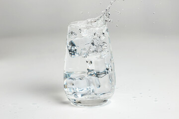 clean water is poured into a glass cup. ice in a glass.