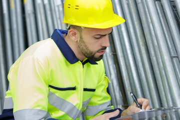 man with hard helmet and clipboard