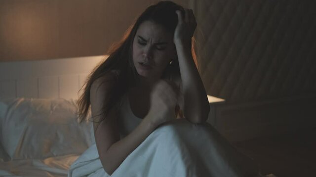 The attractive woman wakes up after nightmare