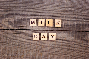 Wooden letters Milk day on old wooden background with