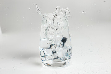 clean water is poured into a glass cup. ice in a glass.