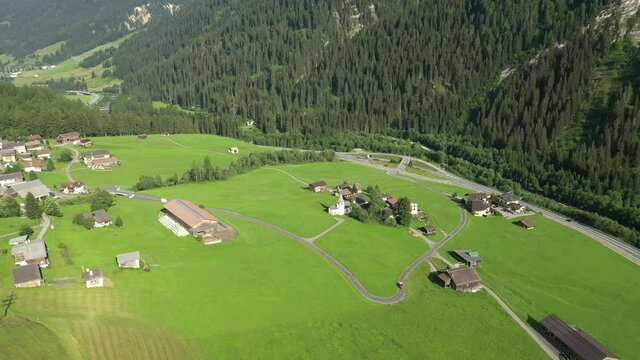 Medels im Rheinwald, Swiss Alps cliffs, green meadows and a village