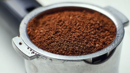 Ground coffee in portafilter. Macro, close-up