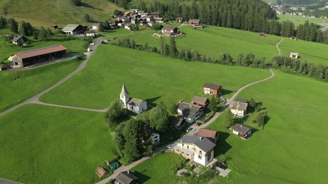 Medels im Rheinwald, Swiss Alps cliffs, green meadows and a village