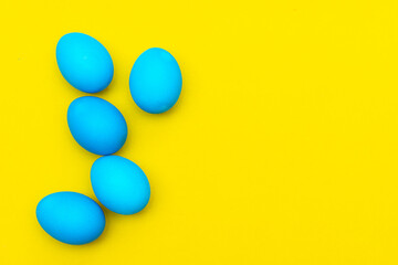 Painted eggs on a yellow background. Chicken eggs on a yellow background. Chicken eggs are colored. Easter. Orthodox holiday. An article about Easter. Article about eggs benefits and harms. Copy space