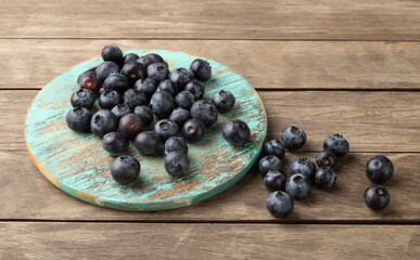 Blueberries on a board over wooden table