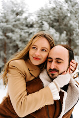 two affectionate person hugging in winter with snow 