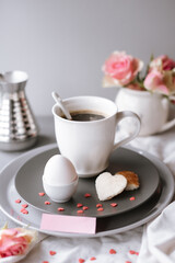 Breakfast romantic still life with coffee, egg, toast, roses and piece of paper. Backspace. Card for valentine's day.