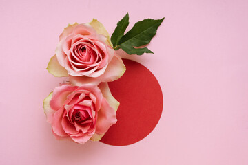 Red circle and pink roses on pink background. Valentines day background.