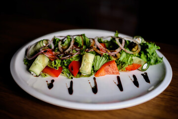 Fresh tasty Greek salad on dark background