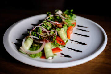 Fresh tasty Greek salad on dark background