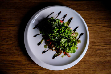 Delicious autumn mushroom salad with grilled mushrooms, tomato, fresh lettuce and rocket served in a bowl with toasted baguette